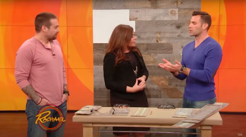 Three people discussing wood samples on a television set