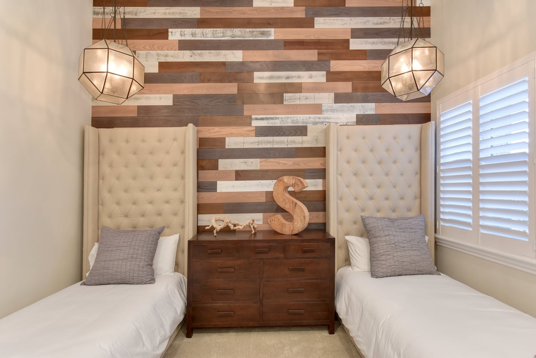 Peel and stick wood panels installed as a bedroom accent wall — Stikwood reclaimed mixed tones