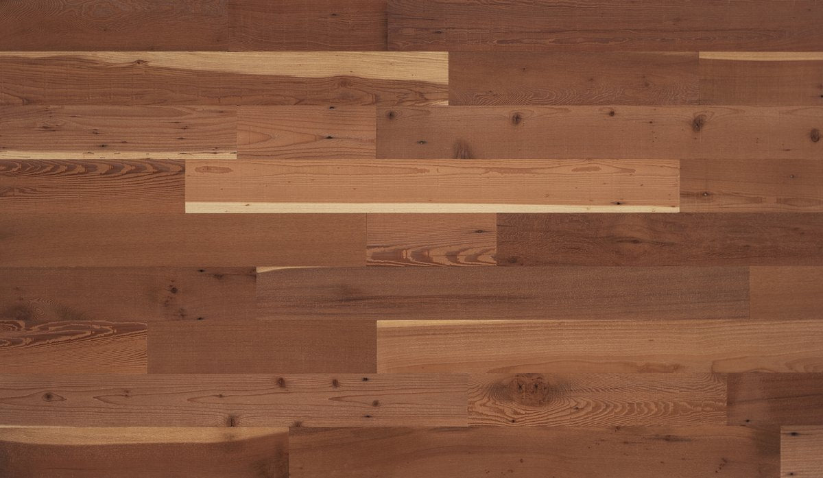 Close-up of Stikwood Reclaimed Natural peel-and-stick wood planks showing warm honey grain tones and rich wood texture — no sealing required