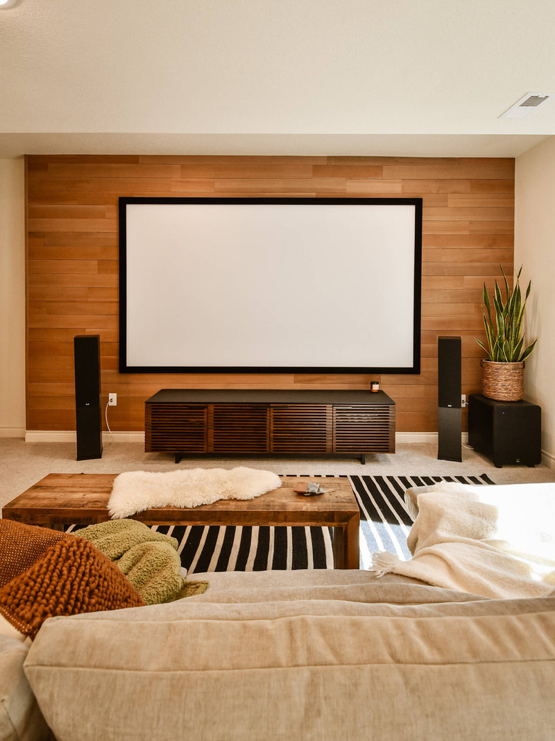 Home theater with a screen set against a wood plank wall