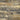 Close-up of Elements Reclaimed Harvest skip-planed wood planks with tan, gold, gray, and brown variation