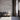 Reclaimed Weathered Wood White planks on a wall behind three chairs and an open doorway