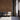 Waiting area with Reclaimed Arabica wood wall, light gray chairs, open door