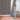Woman installing Driftwood Slatwood acoustic panels on a wall