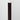 Black Cherry peel-and-stick wood plank with natural grain detail displayed vertically on white wall