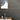 Cobblestone Peel & Stick Wood Wall Planks behind a small table with decor