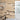 Wood plank wall with black and white geometric shapes, basketball hoop, and partial view of a bathroom