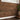 Reclaimed Arabica Stikwood planks on a wall, with a window, plant, and boots nearby