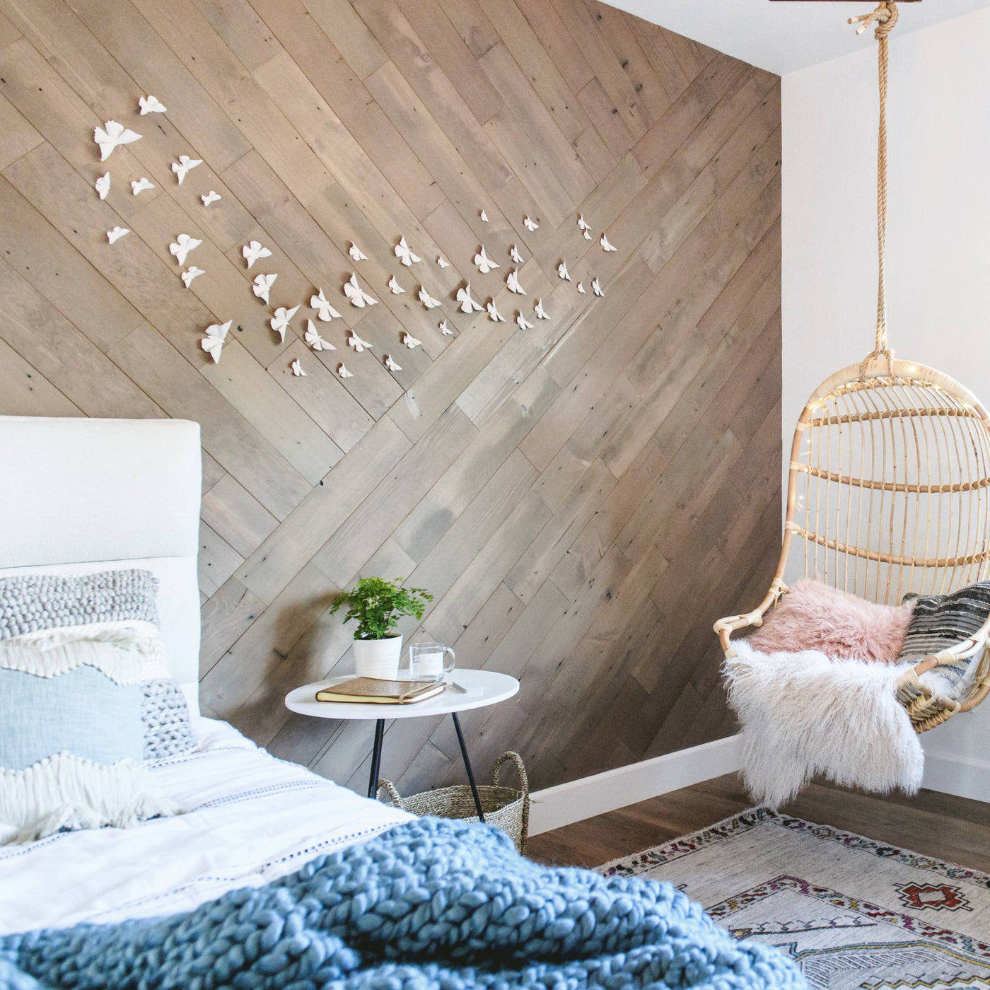 Bedroom scene with Reclaimed Rustic Slate planks in a chevron pattern, plus butterfly wall art