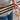 Person peeling the adhesive backing from a Reclaimed Sierra Gold wood plank