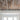 Reclaimed weathered wood planks installed on ceiling above white trim and windows