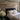 Reclaimed wood wall planks in gray and tan tones installed horizontally behind a black bed frame with white bedding