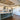 Reclaimed wood peel-and-stick planks covering kitchen ceiling in warm rustic tones above modern white cabinetry