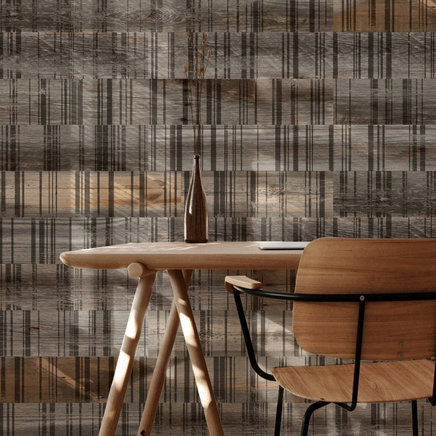 Wooden desk and chair against a wall covered in Linea peel-and-stick wood planks