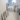 Natural wood planks with whitewashed finish arranged on a light tiled bathroom floor near a bathtub