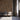 Wall clad in Grid Buckskin Mosaic Wood Tiles behind three chairs