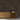 Gunstock mosaic wood tiles on a wall behind a wooden console table