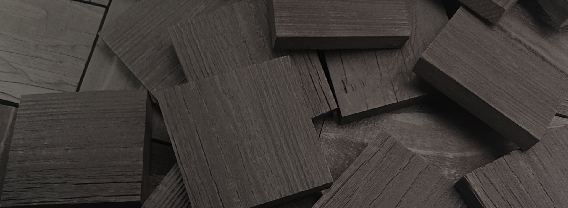 Close-up of dark natural wood planks stacked together showcasing texture for peel and stick accent wall project