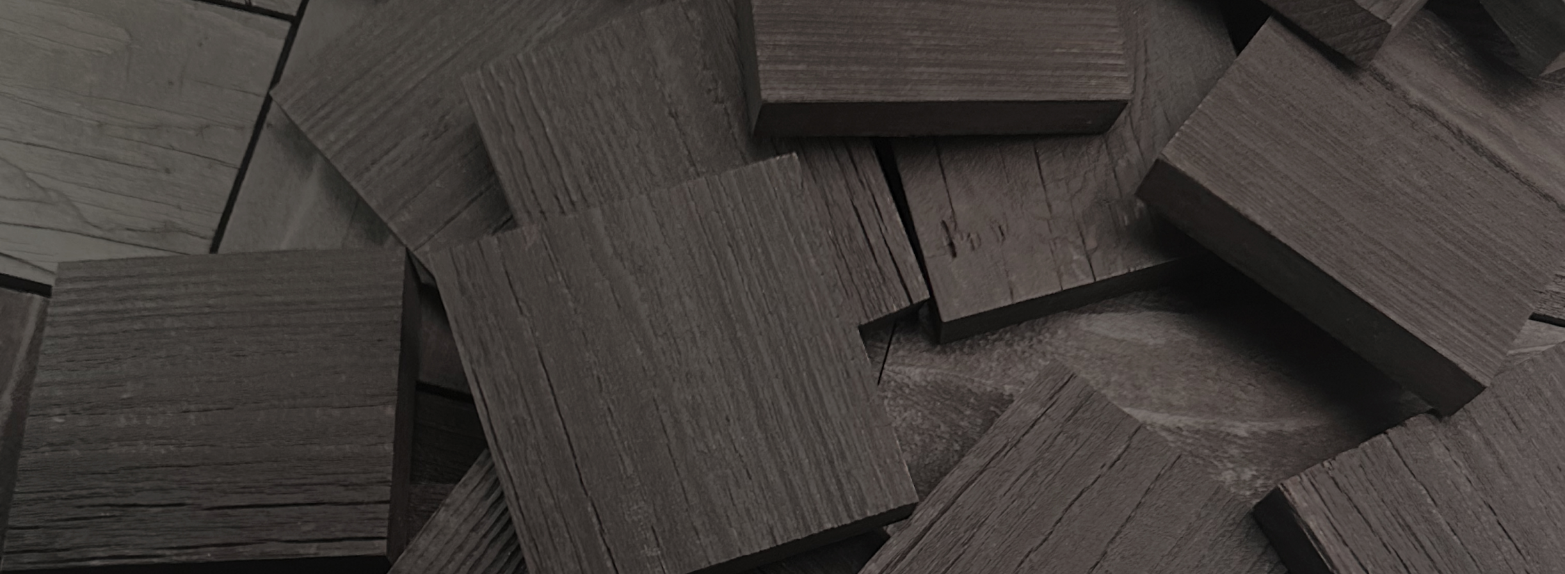 Close-up of dark natural wood planks stacked together showcasing texture for peel and stick accent wall project