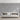 Living room scene with a white couch against a wall covered in Ashlar1 Glacier mosaic wood tiles