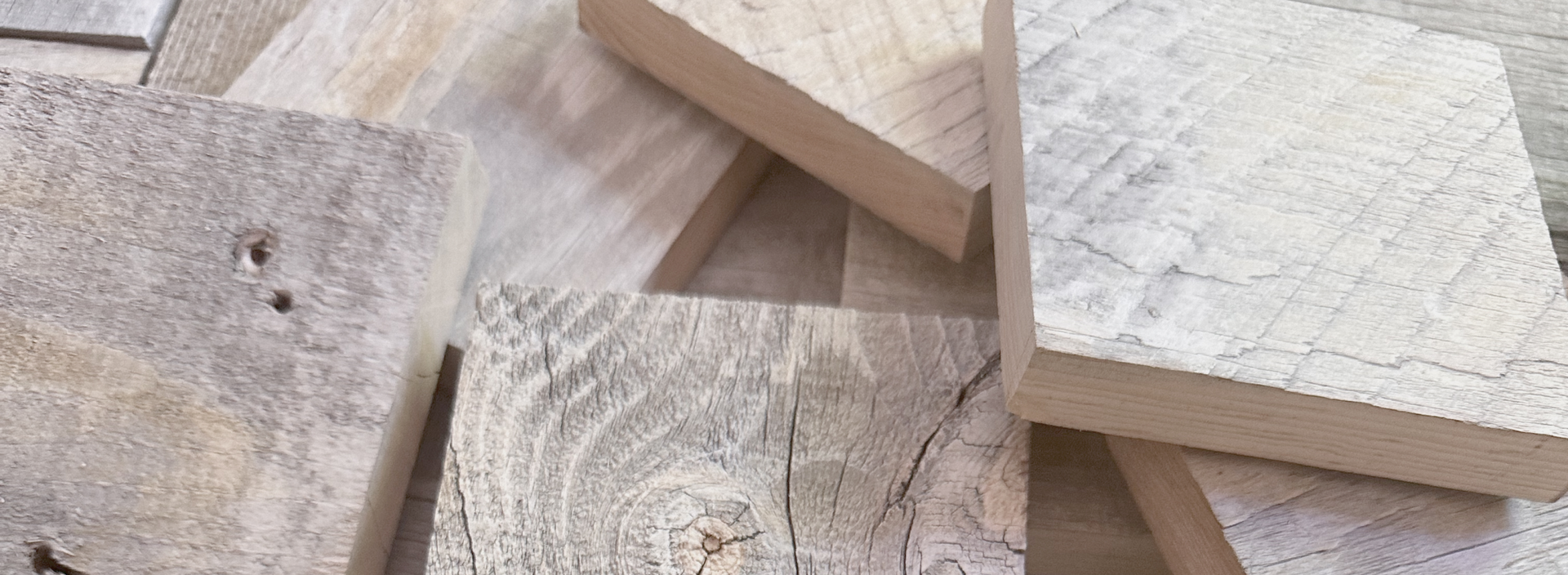 Close-up of natural wood plank samples showcasing varied textures and tones for peel and stick accent walls