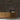 Bond Gunstock Mosaic Wood Wall Tiles behind a wood credenza with vases and books