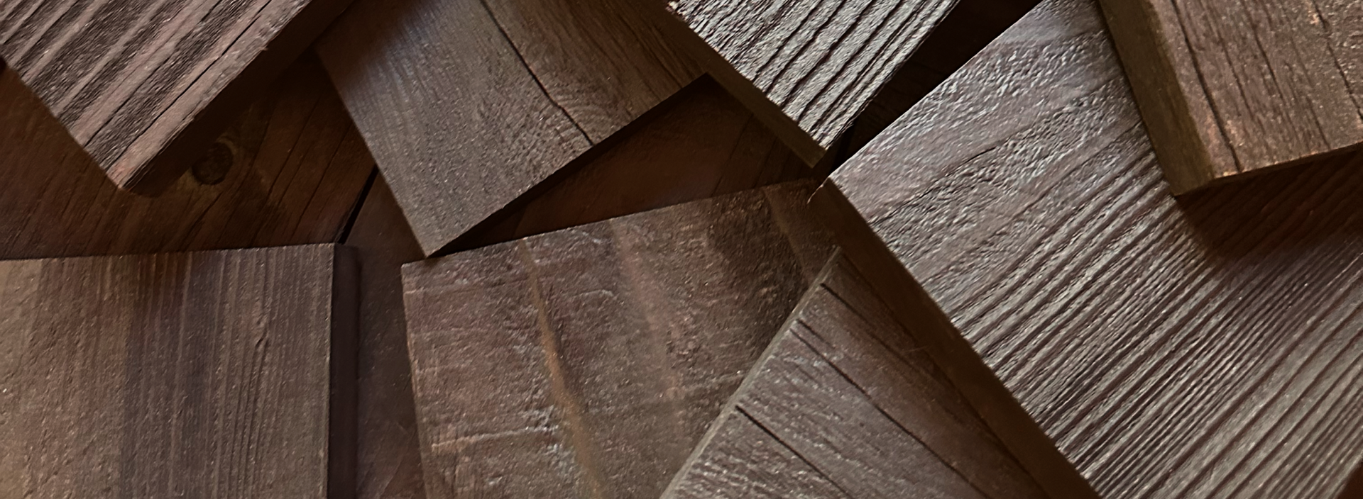 Close up of natural dark wood planks with textured grain showing a peel and stick real wood look