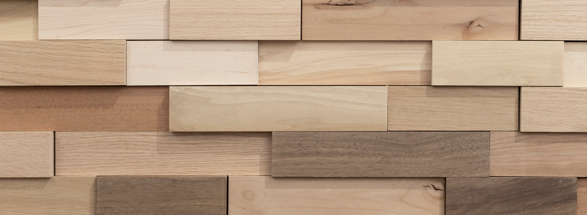 Close-up of natural wood planks in varying shades and textures creating a peel and stick accent wall pattern
