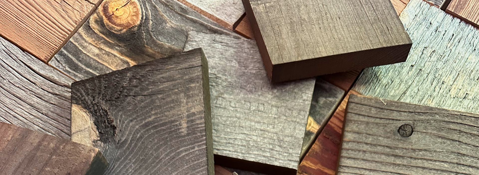 Assortment of natural wood plank samples showing various colors and textures for a peel and stick accent wall project