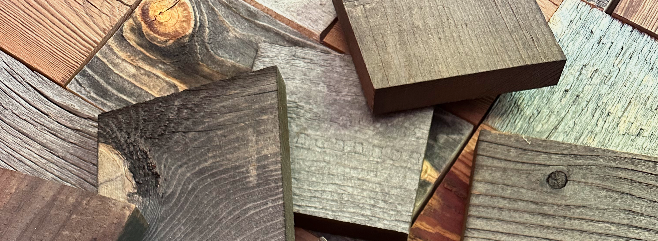 Assortment of natural wood plank samples showing various colors and textures for a peel and stick accent wall project