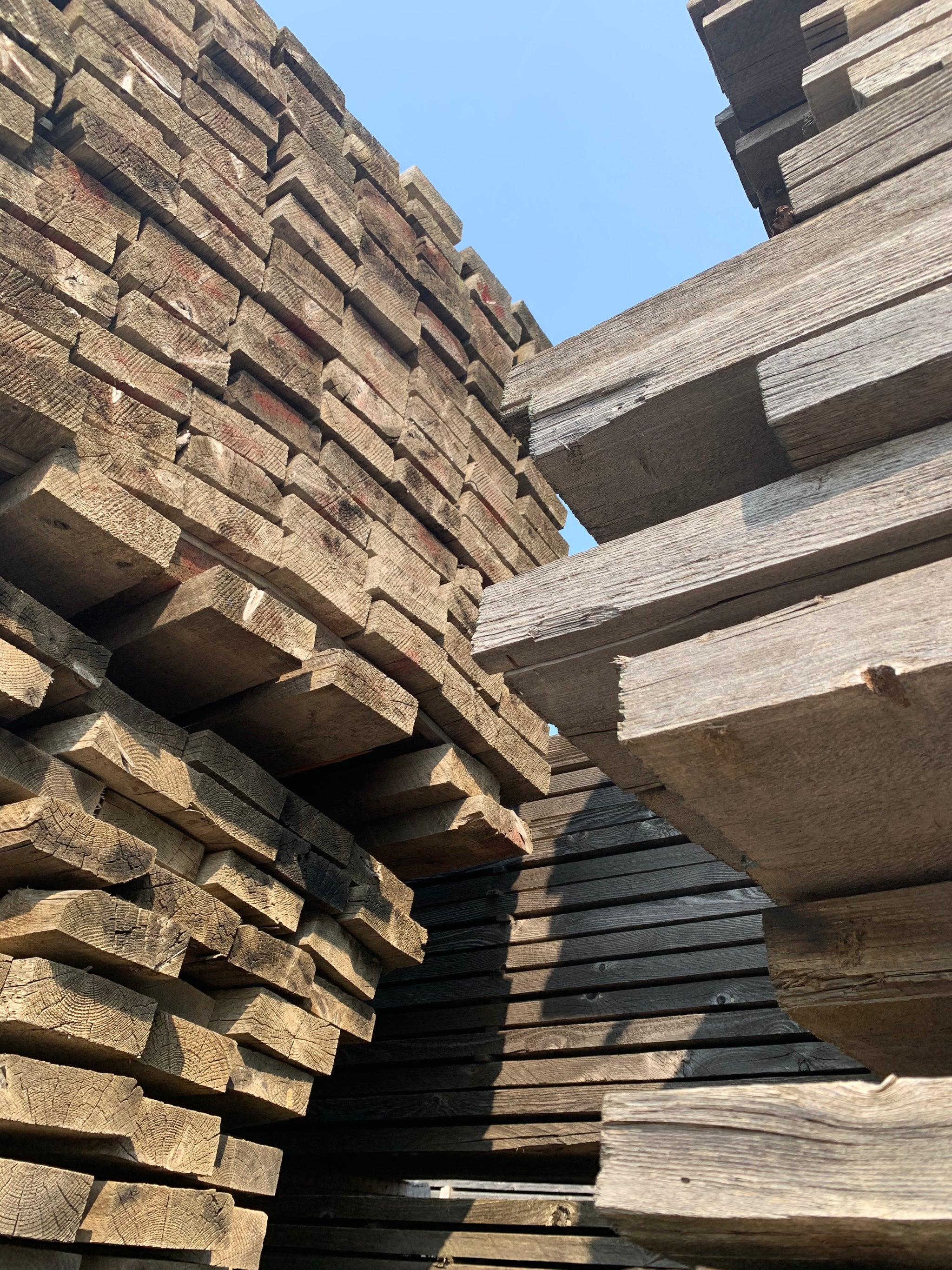 Real reclaimed wood waiting at the factory to be milled into planks
