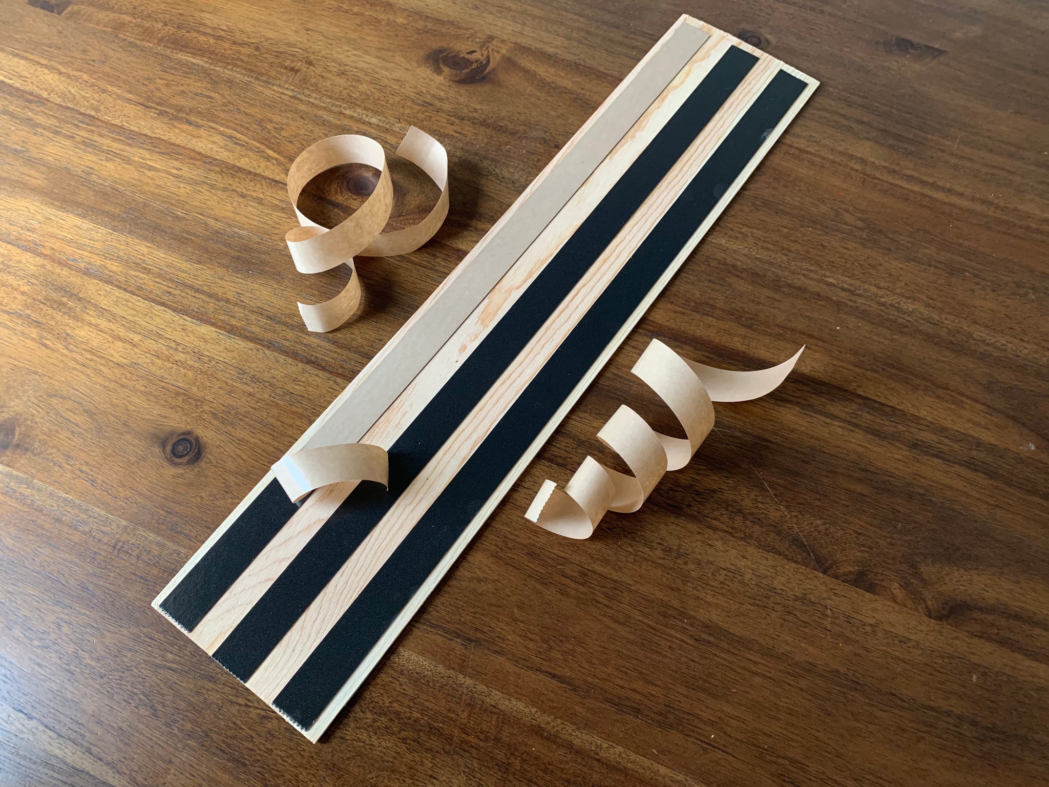 Adhesive foam strips are applied to the back of each plank